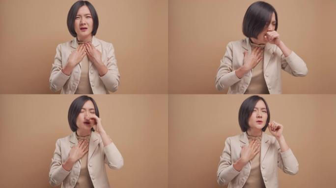 亚洲女商人生病了，发热站在米色背景上孤立。4k视频