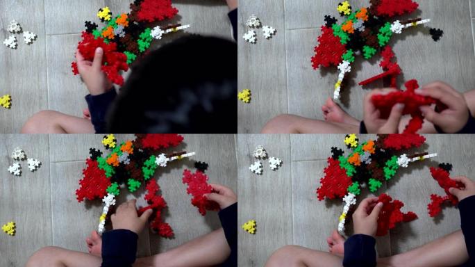 小孩子在室内玩许多彩色塑料玩具。专注于机器人形状的玩具。