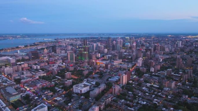 蒙特利尔魁北克航空v102在黄昏时分飞越市区平移，城市景观