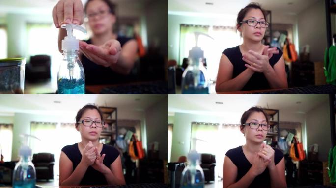 亚洲妇女消毒她的手消毒在家庭办公室。