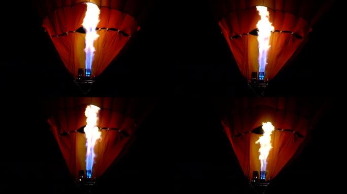 夜间在彩色热气球中飞过地面的丙烷燃气燃烧器的特写视频