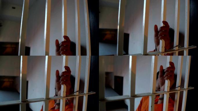 亚洲男子在铁监狱绝望囚犯概念