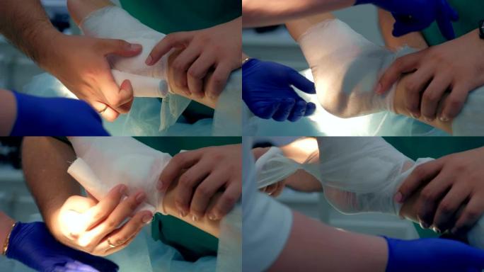 护士和医生外科医生在手术后包扎病人的腿脚，特写视图。