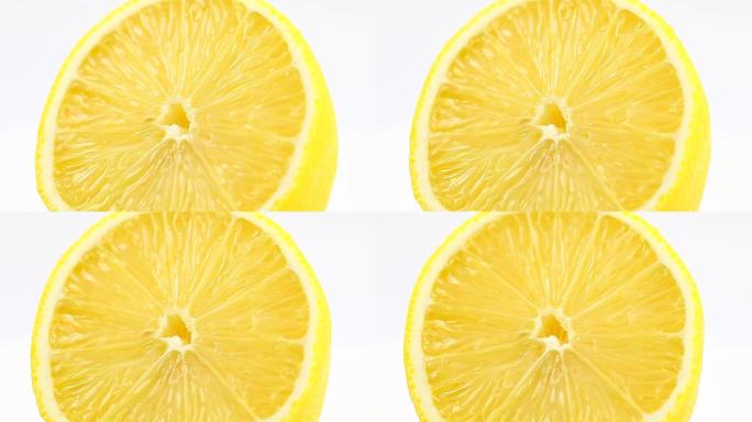 柠檬垂直旋转。切柑橘多汁的黄色水果。宏观特写镜头。
