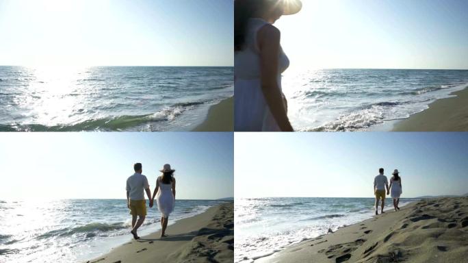 夫妇沿着靠近水的海滩散步