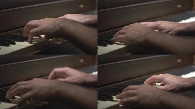 男人的手弹钢琴的特写