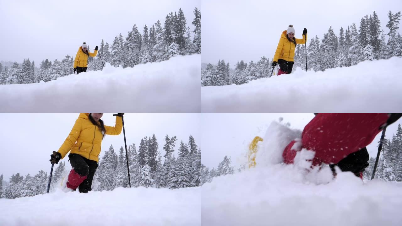 冬季旅行者。一名年轻女子的慢动作游客雪鞋在深雪中行走，享受着冬日的高山。