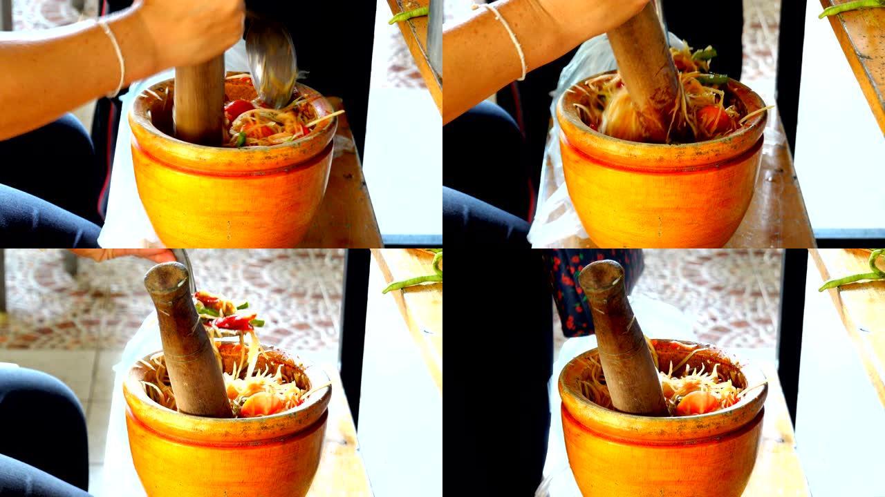 专业厨师在泰国做辣木瓜沙拉或香菜