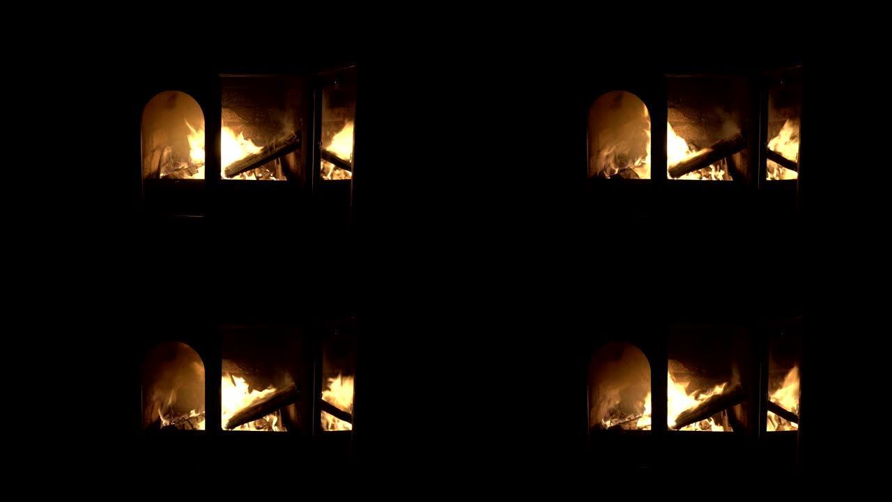 明亮而强烈的火在家庭壁炉的玻璃门后面燃烧。一扇门是开着的。没有人开枪。概念。特写。4K