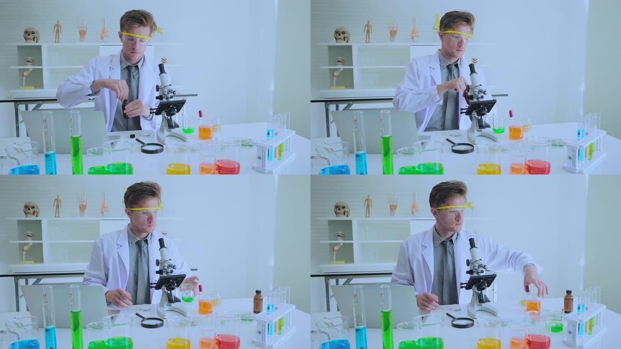 4K; 男性科学家研究员在实验室里看着显微镜。
