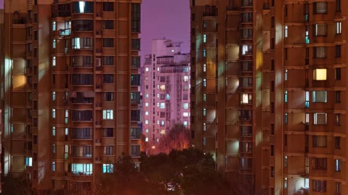 上海公寓楼的昼夜过渡时间流逝。中国拥挤的城市，晚上灯火通明。城市大都市的4k时间流逝。