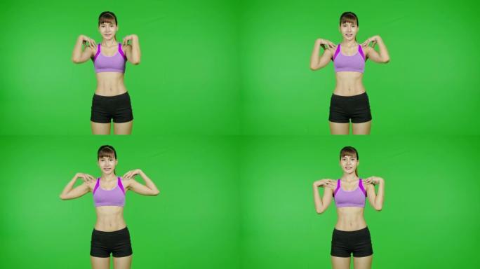 肩部热身向前，绿屏，锻炼，伸展。适合年轻的亚洲运动妇女在紫色的布料做热身运动在镜头前。
