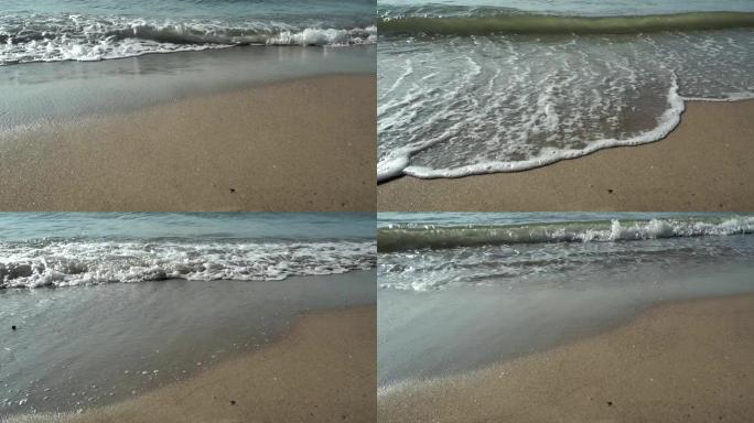 海滩，泡沫海洋，海浪洗沙。海浪冲击沙滩。海浪的声音
