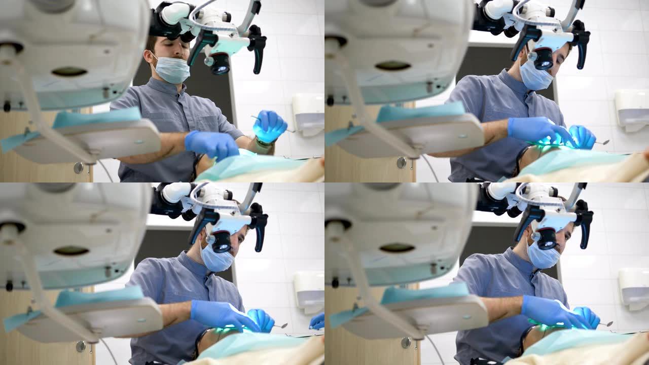 牙医使用现代电子显微镜治疗患者的龋齿