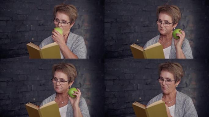 中年妇女在家吃苹果看书