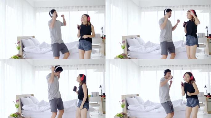 亚洲夫妇在卧室里跳舞快乐地庆祝