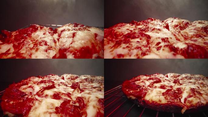 超特写广角微距拍摄意大利辣香肠在美味的热气腾腾的深盘意大利辣香肠比萨饼新鲜出炉在加热灯下的冷却架上，