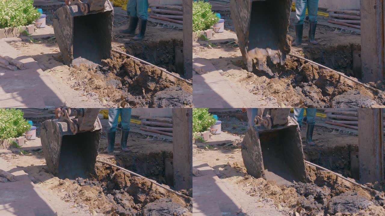 挖坑的挖掘机。桶撞到了地上。