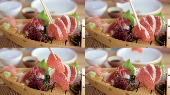 吃鲑鱼生鱼片。三文鱼生食一次性筷子