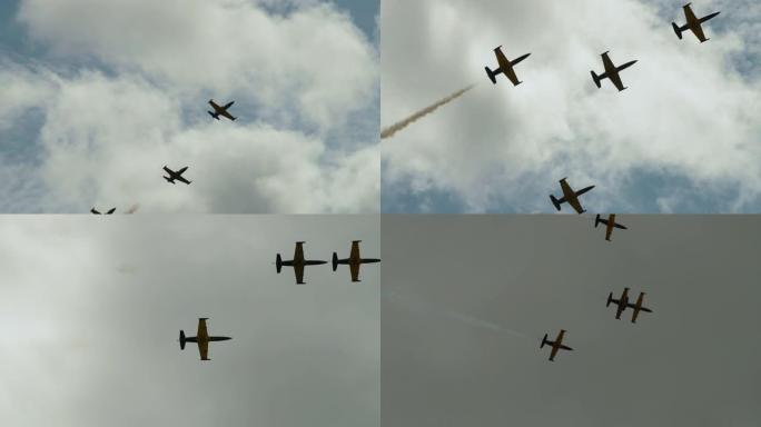 多云的天空中有四架喷气式飞机