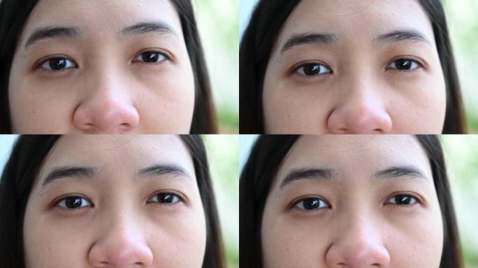 4k亚洲女人眼睛特写，沉思，亚洲男人慢动作。一个成年人看着镜头想了些什么。亚洲女性特写概念背景。