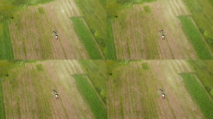 农民堆放干草红拖拉机空中高角度拍摄