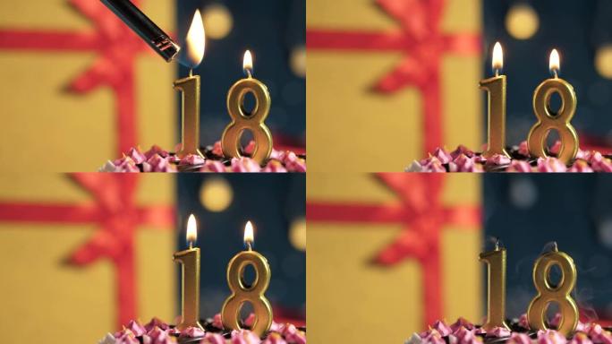 生日蛋糕18号点火器燃烧的金色蜡烛，蓝色背景礼物黄色盒子用红丝带绑起来。特写和慢动作