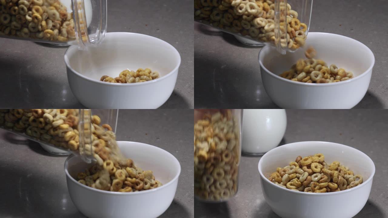 健康早餐。一个女人从一个透明的盒子里把玉米片倒入一个白色的碗里