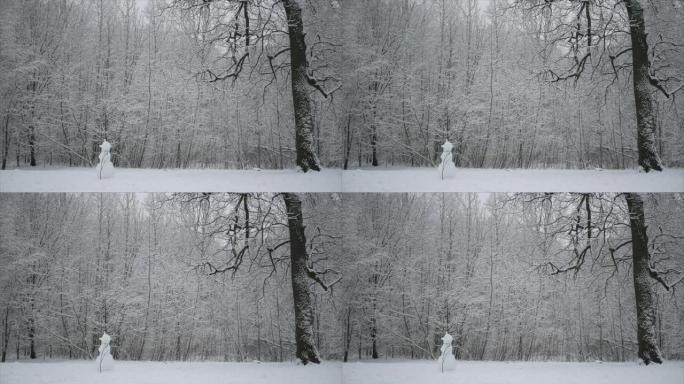 冬天的森林里正在下雪。雪人站在森林林间空地上。