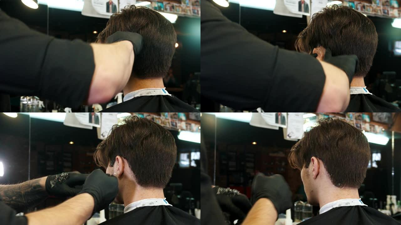一名男士理发师使用刀片将剃须膏涂在头发边缘进行画龙点睛