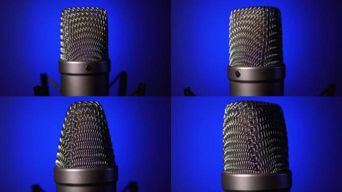 Studio Condenser Microphone Rotates on Blue Backgr