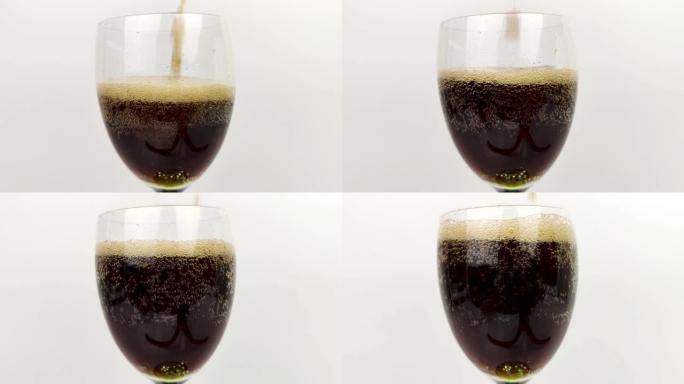 苏打水正在倒入玻璃杯中。微距视频，将深色饮料倒入透明杯子中。