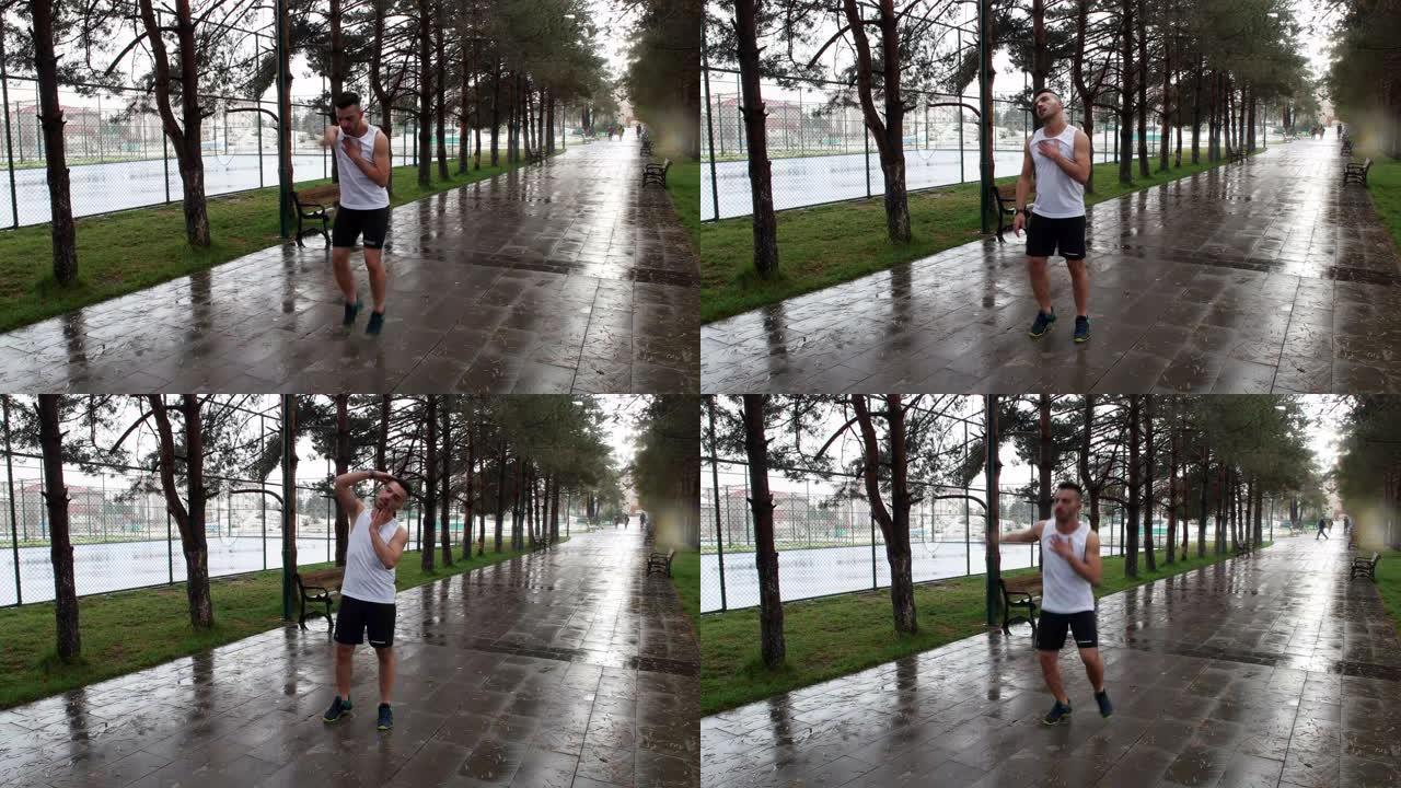 年轻的运动员在雨中锻炼