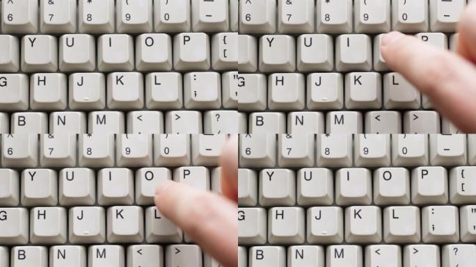 男性手指按下白色键盘上的O按钮。慢动作和宏观视图