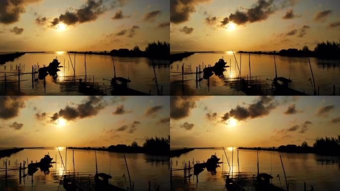 一艘古老的渔船的美丽停泊在早晨的阳光下，鸟瞰日出。版税高品质免费素材，早上带着金色阳光的海滩上渔船的