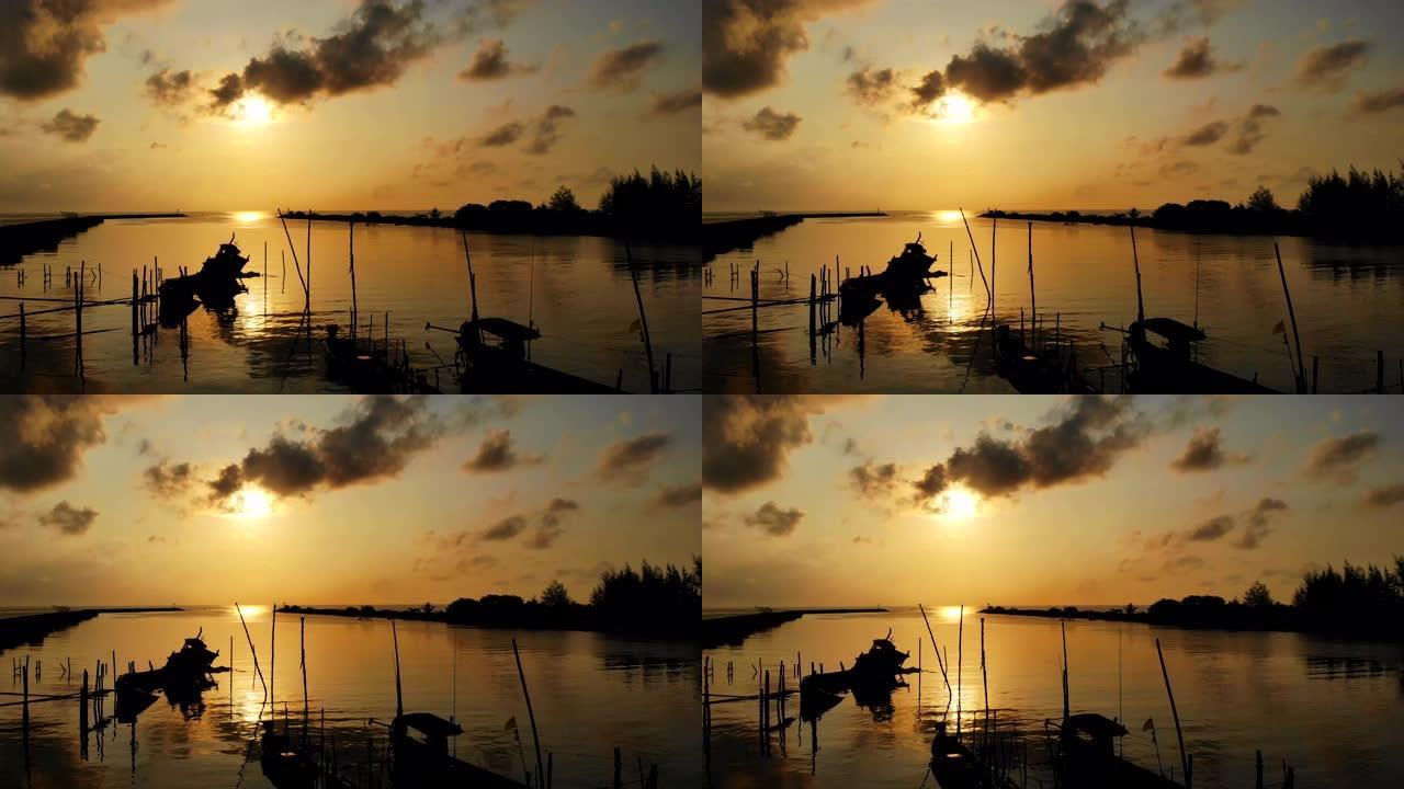 一艘古老的渔船的美丽停泊在早晨的阳光下，鸟瞰日出。版税高品质免费素材，早上带着金色阳光的海滩上渔船的