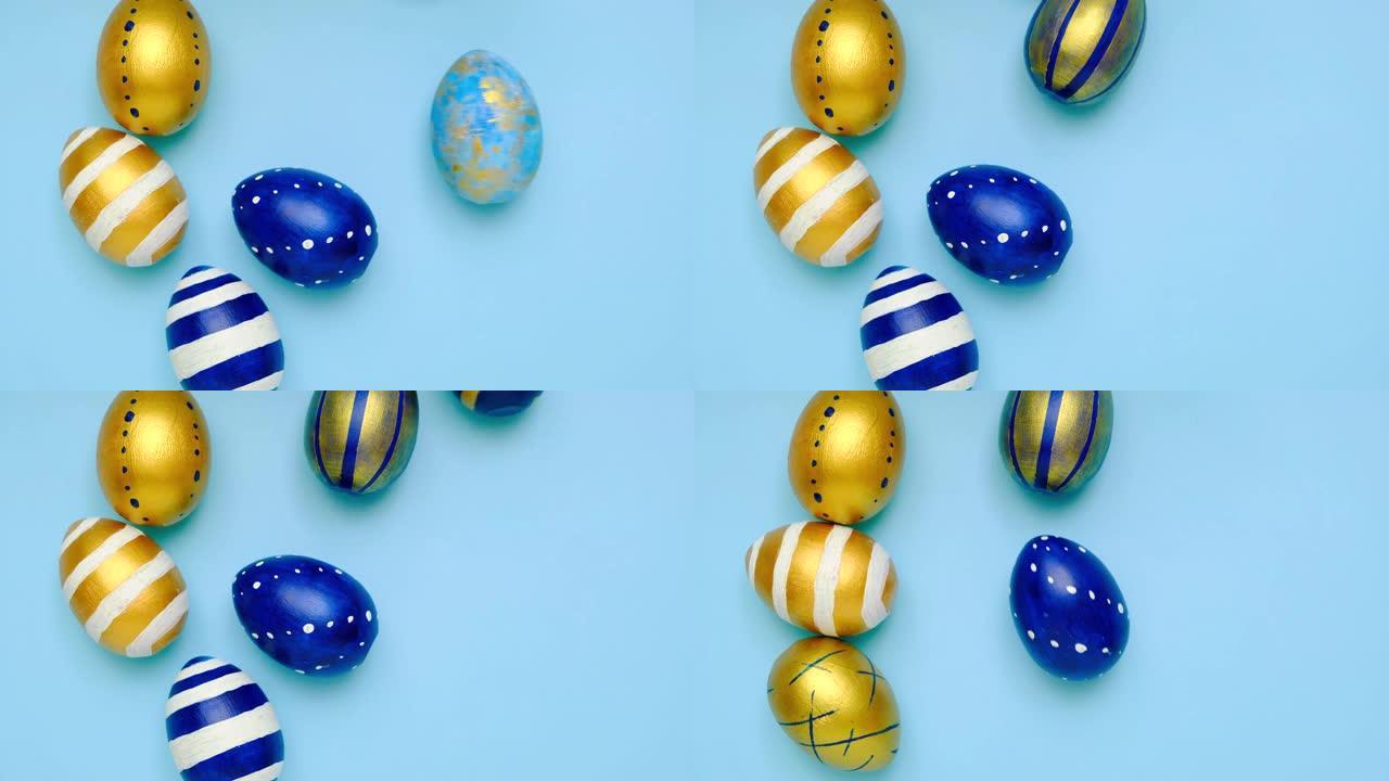 复活节彩蛋在滚动，互相敲在蓝色的桌子上。鸡蛋时尚彩色经典蓝色、白色和金色。复活节快乐。最小风格。顶视