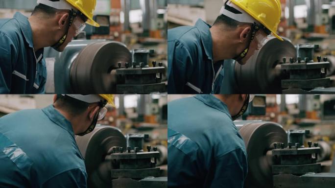 操作工业金属切割机的年轻工业工人，调整机器，特写。慢动作，亚洲华裔男性，工作服。工业和制造概念。