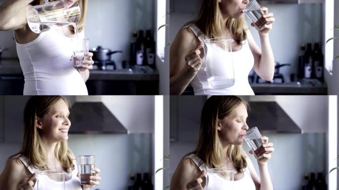 美女孕妇在玻璃杯里倒水喝