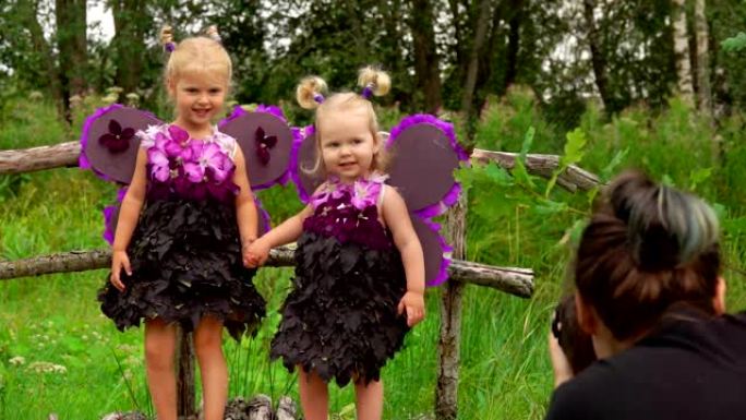 摄影师拍摄美丽的女孩玩紫罗兰蝴蝶的照片