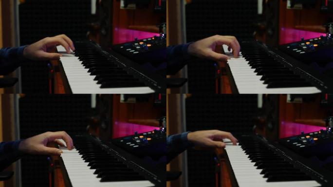 男性手在家庭音乐工作室演奏钢琴midi键盘。声音制作人在录音室创作流行摇滚歌曲。近距离弹奏电子琴。女