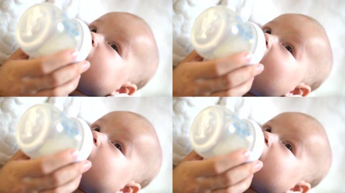 可爱的小婴儿用奶瓶吃奶的特写镜头