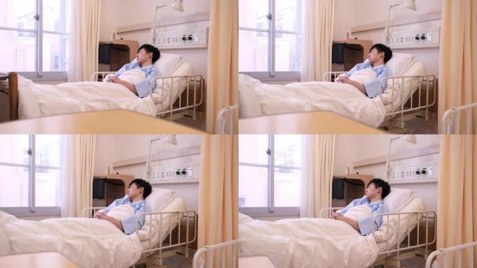 严重的日本年轻男性患者在医院病床上睡觉