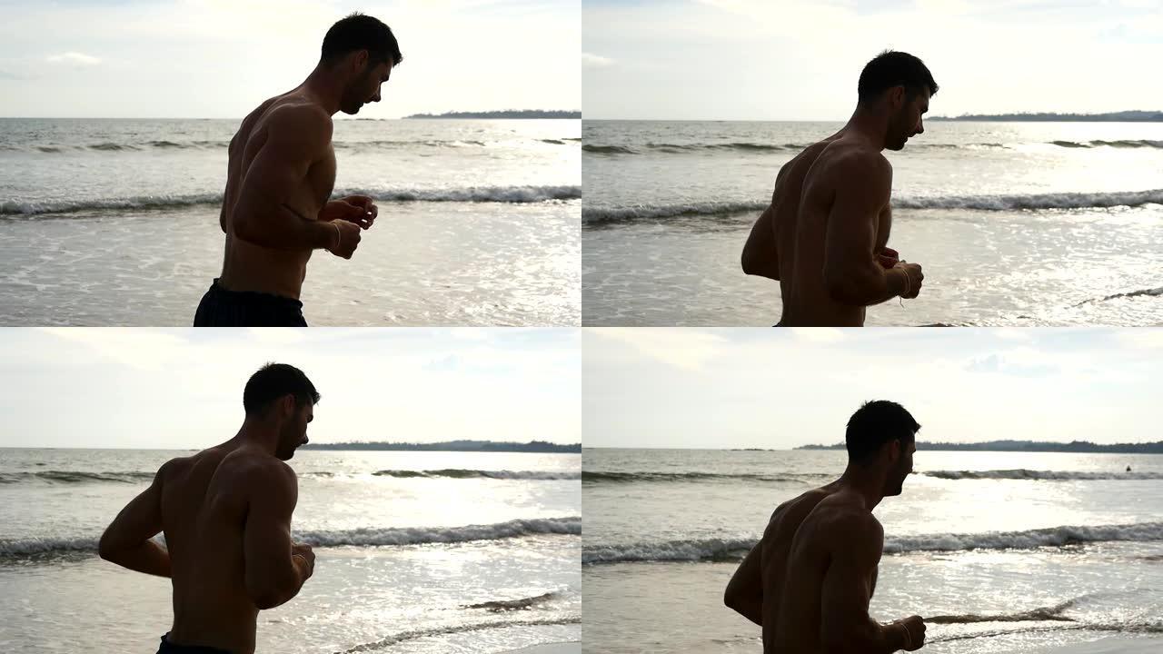 年轻的运动型男子沿着海边奔跑。运动帅哥在美丽的海景背景下慢跑。在海边锻炼的男运动员。健康积极生活方式