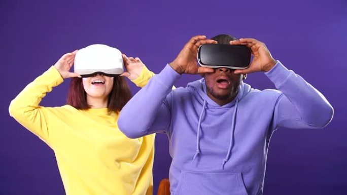 年轻的跨种族夫妇第一次使用虚拟现实耳机