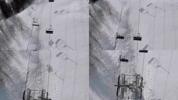 雪坡上交通滑雪者滑雪缆车的空中俯视图。无人机飞越升降椅