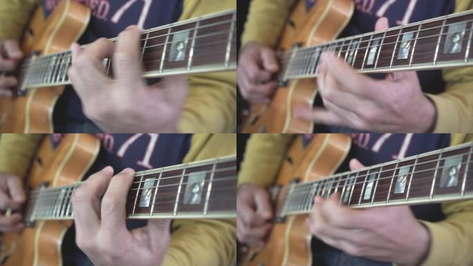 吉他大师的手在脖子上滑动的特写镜头，在天然轻质木材的半声学空心体吉他上弹奏和弦，音阶和独奏