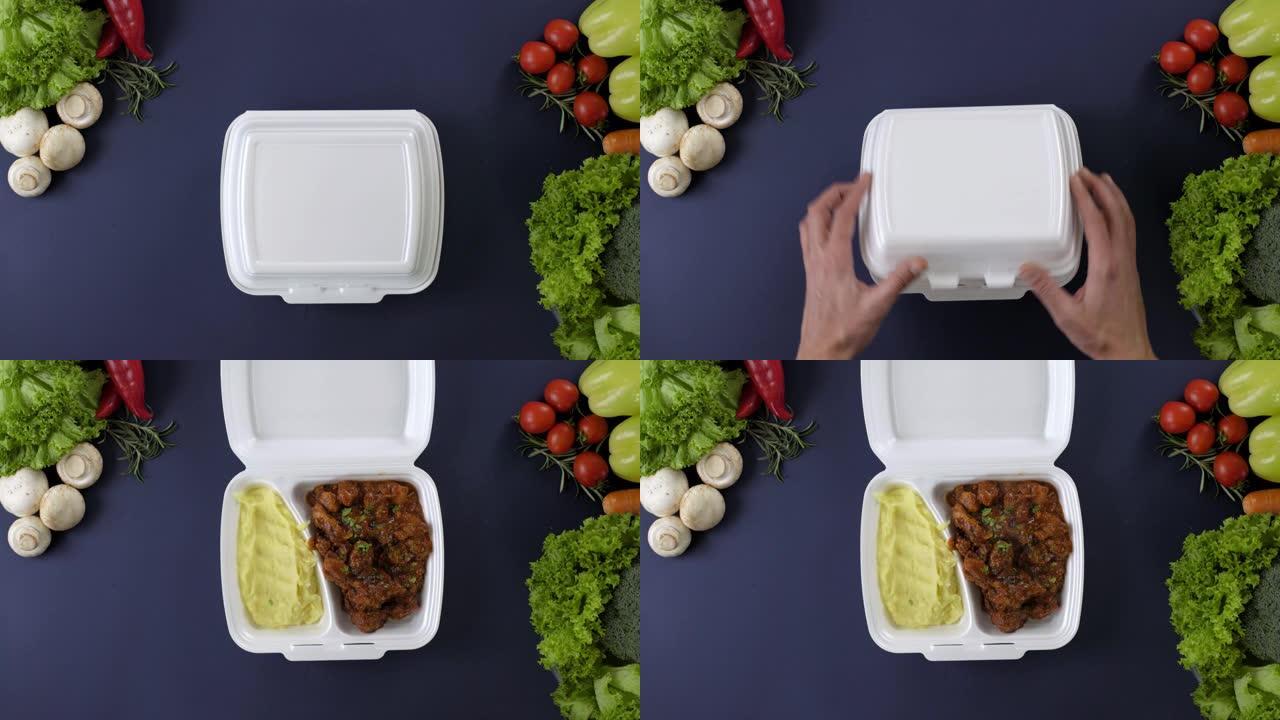 将外卖食品包装在聚苯乙烯泡沫塑料盒中。用炖牛肉和土豆泥打开新鲜的外卖套餐