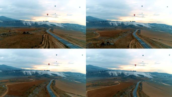 热空气气球在土耳其德尼兹利的棉花堡石灰华上空飞行