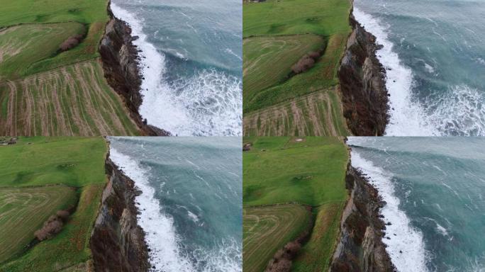 高高的绿色悬崖和海浪的4K镜头